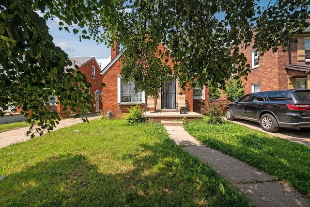 obstructed view of property with a front yard