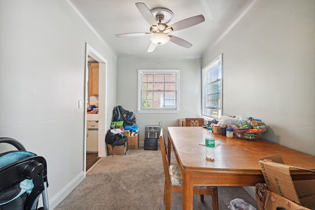 carpeted dining room featuring ceiling fan