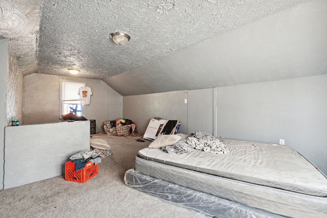 bedroom with carpet, a textured ceiling, and lofted ceiling