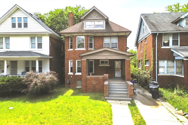 4443 Oregon St, Detroit, MI 48204 - traditional style home featuring a porch, a chimney, brick siding, and a front yard