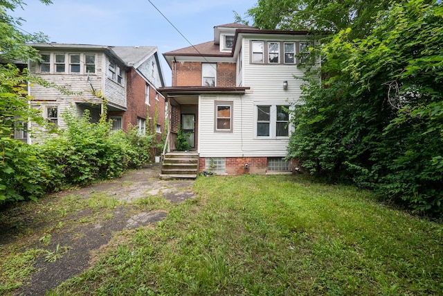 back of house with a lawn