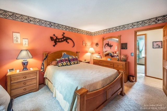 bedroom featuring light carpet