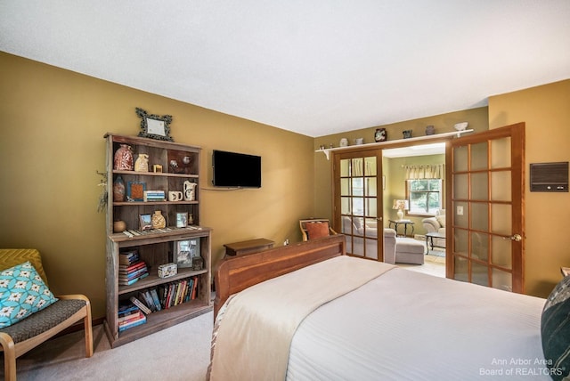 bedroom featuring light carpet and french doors