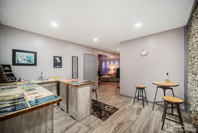 interior space featuring sink and light hardwood / wood-style flooring