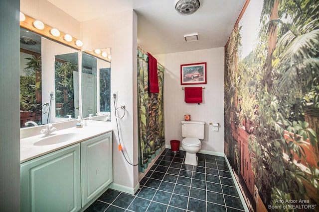 bathroom with tile patterned floors, vanity, and toilet