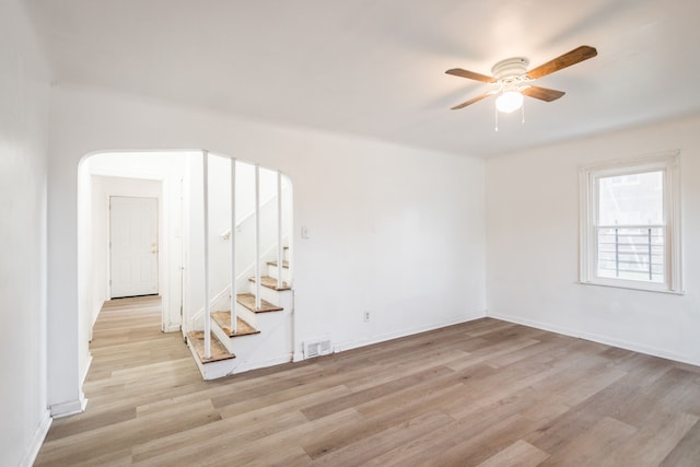 empty room with ceiling fan and light wood-type flooring