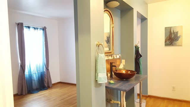 677 Selden St, Detroit, MI 48201 - hall with a sink, light wood finished floors, and baseboards