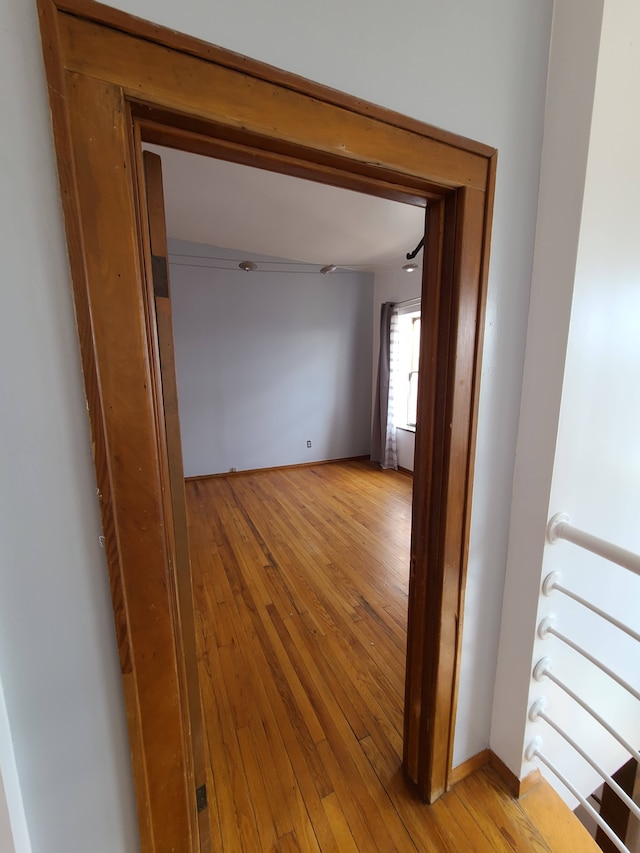 677 Selden St, Detroit, MI 48201 - hallway with light wood-style floors and an upstairs landing