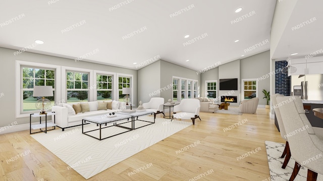 living room featuring lofted ceiling, a fireplace, and light wood-type flooring