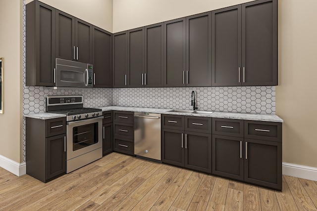 1111 Angara Dr Unit 1, Rochester Hills, MI 48309 - kitchen featuring stainless steel appliances, a sink, light wood-style floors, and baseboards