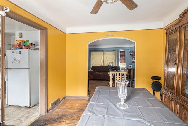 dining room with hardwood / wood-style floors and ceiling fan