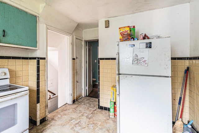 kitchen featuring tile walls and white appliances