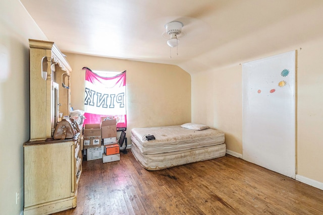 bedroom with ceiling fan, dark hardwood / wood-style flooring, and vaulted ceiling