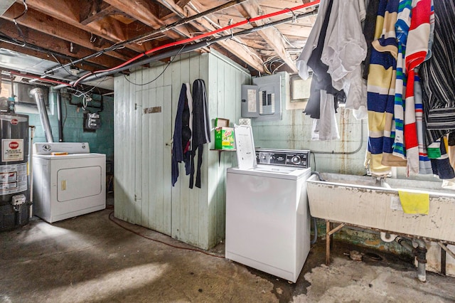 basement featuring washing machine and dryer, water heater, electric panel, and sink