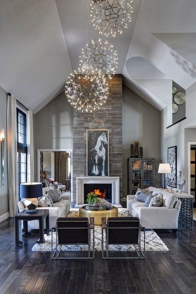 4701 Pinnacle Blvd, Rochester, MI 48306 - living area featuring high vaulted ceiling, a chandelier, wood finished floors, a high end fireplace, and baseboards