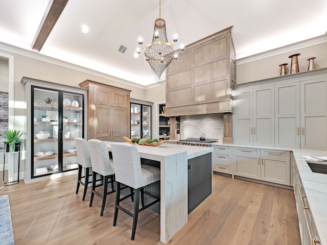4701 Pinnacle Blvd, Rochester, MI 48306 - kitchen with a chandelier, ornamental molding, a center island, a breakfast bar, and decorative backsplash