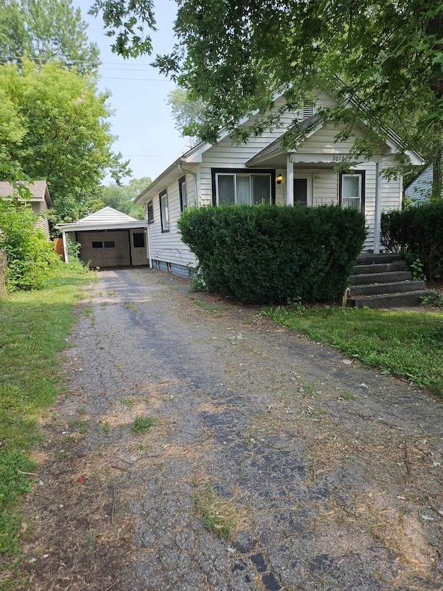 view of front facade featuring a garage and an outdoor structure