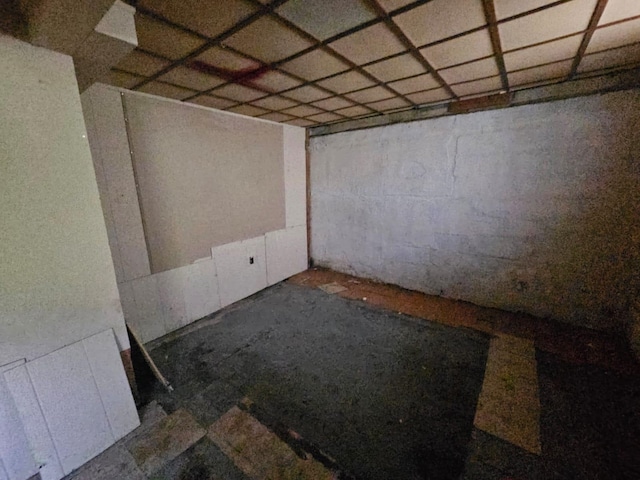 basement with a paneled ceiling