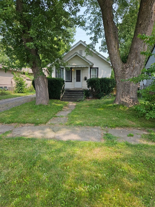 bungalow-style house featuring a front yard