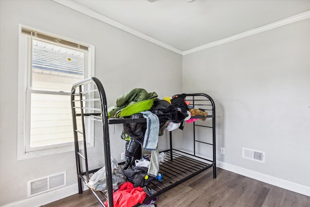 workout area with crown molding and dark wood-type flooring