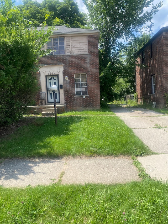 8883 Rutherford St, Detroit, MI 48228 - view of front of home with brick siding, driveway, and a front lawn