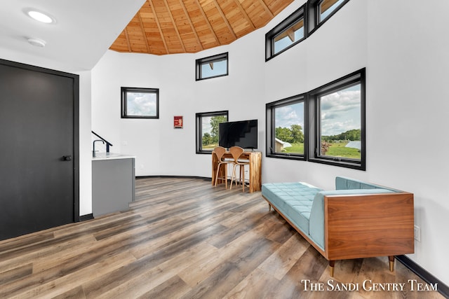 sitting room featuring wood ceiling, dark wood-type flooring, and high vaulted ceiling