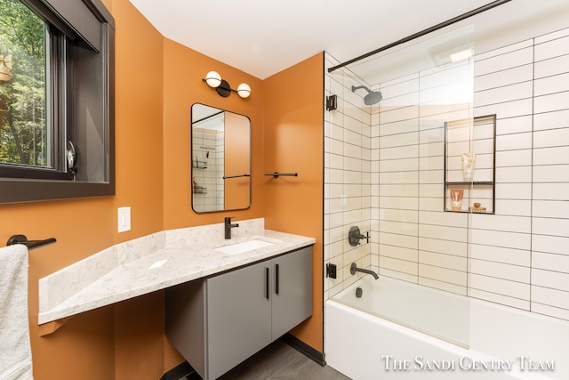 bathroom with vanity and tiled shower / bath