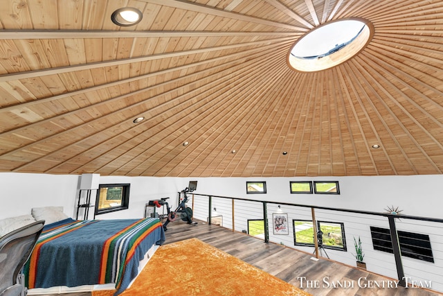 interior space with vaulted ceiling with beams, hardwood / wood-style flooring, and wooden ceiling