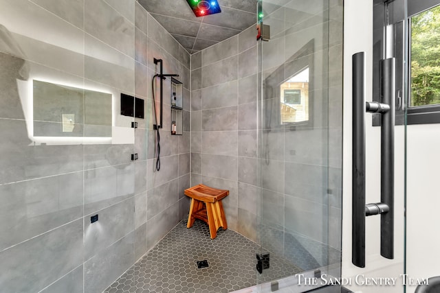 bathroom featuring a shower with door