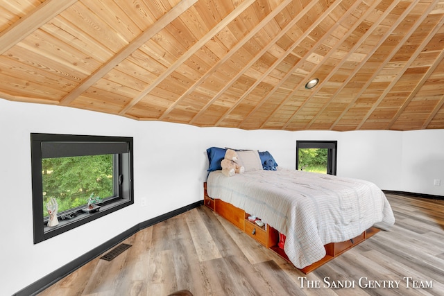 bedroom featuring vaulted ceiling with beams, multiple windows, and wooden ceiling