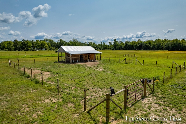 view of yard featuring a rural view and an outbuilding