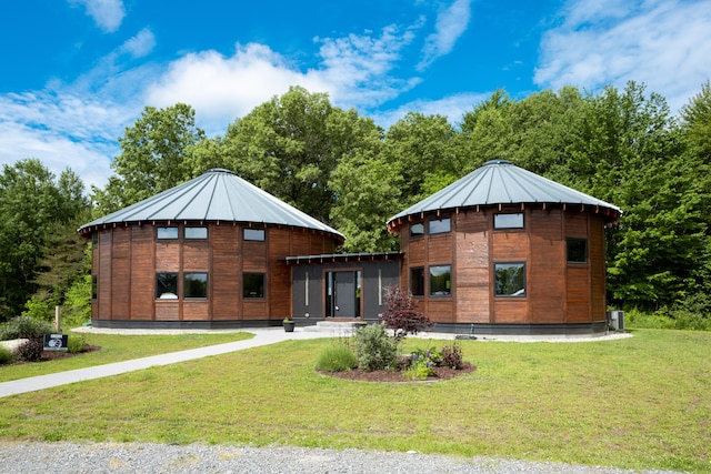 rear view of house featuring a yard