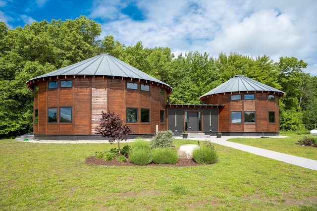 rear view of property featuring a lawn