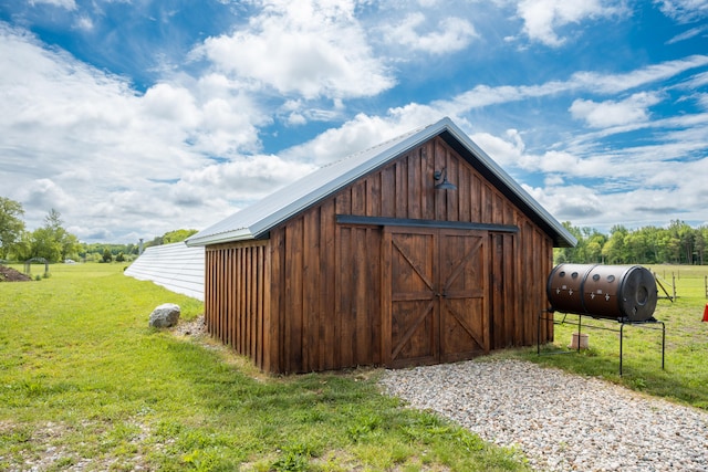 view of outdoor structure featuring a lawn