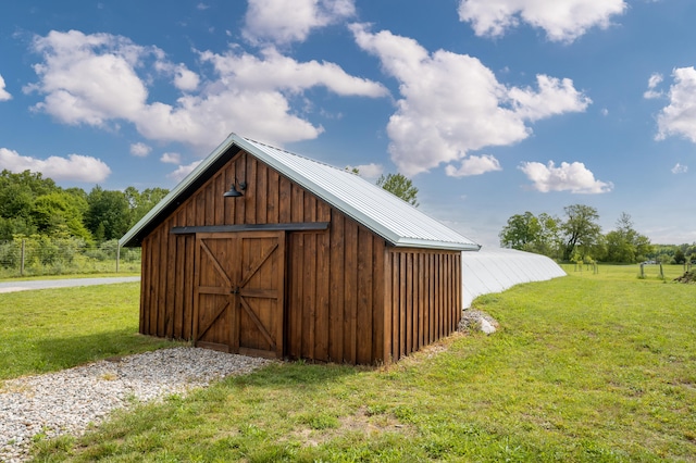 view of outbuilding featuring a lawn