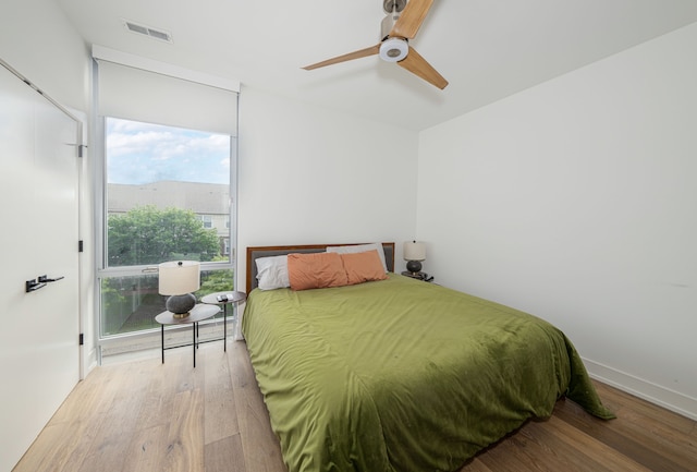 bedroom featuring ceiling fan and light hardwood / wood-style flooring