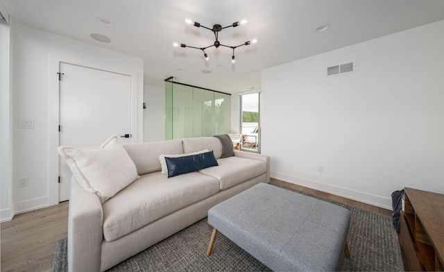2813 Brush St Unit 99, Detroit, MI 48201 - living area with wood finished floors, baseboards, and a chandelier