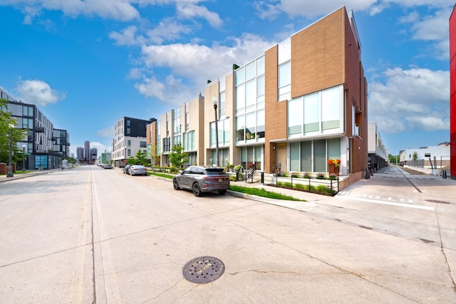 2813 Brush St Unit 99, Detroit, MI 48201 - view of concrete street featuring sidewalks, a residential view, and curbs
