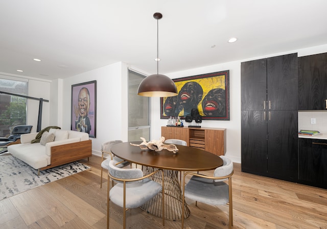 dining area featuring light wood-type flooring