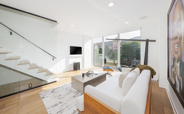 2813 Brush St Unit 99, Detroit, MI 48201 - living area featuring stairs, wood finished floors, a wall of windows, and recessed lighting