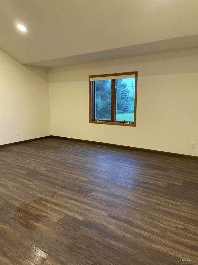 unfurnished room with dark hardwood / wood-style floors