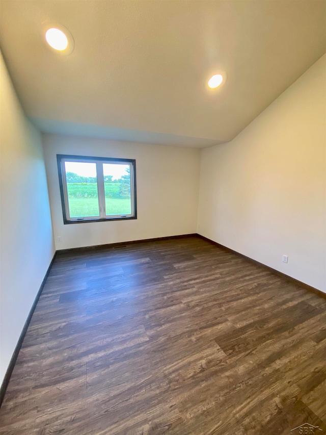 empty room with dark hardwood / wood-style floors