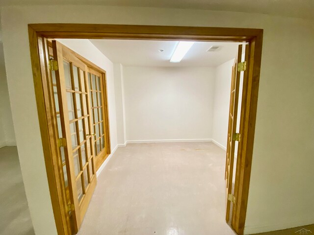 hallway featuring light colored carpet