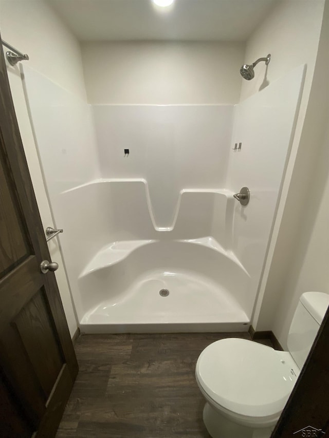 3879 Kochville Rd, Saginaw, MI 48604 - full bathroom featuring toilet, a shower, and wood finished floors