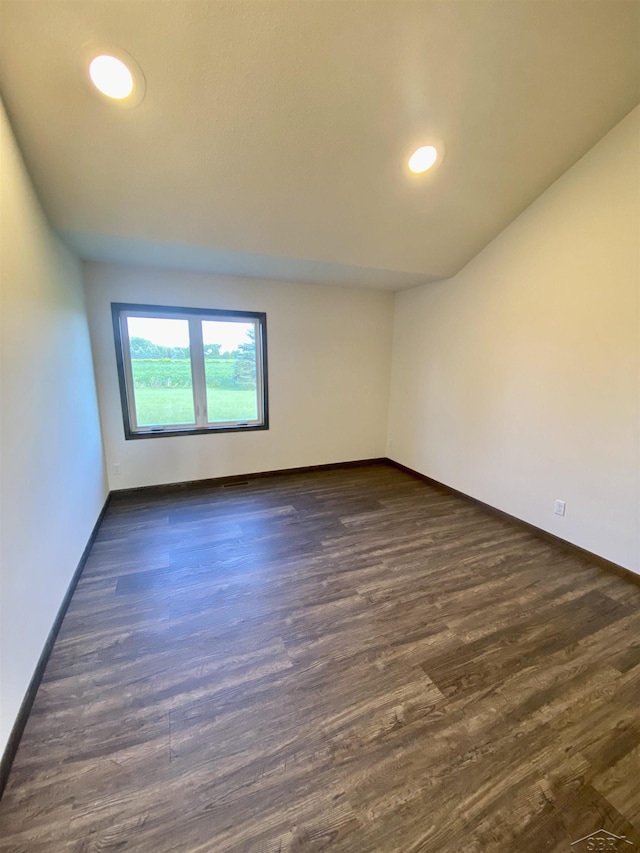 3879 Kochville Rd, Saginaw, MI 48604 - spare room featuring baseboards, dark wood-style floors, and recessed lighting