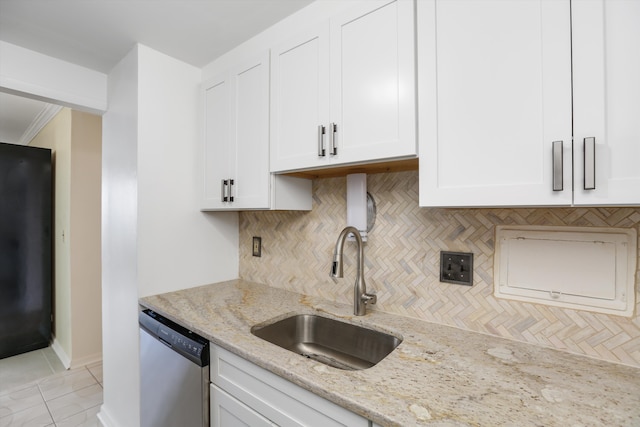 kitchen featuring sink, stainless steel dishwasher, tasteful backsplash, light stone counters, and white cabinetry