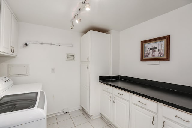 laundry area featuring cabinets, washer / dryer, and light tile patterned floors