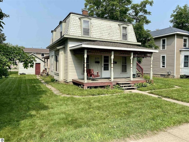 628 S Oak St, Mount Pleasant, MI 48858 - victorian home with mansard roof, a porch, a front lawn, and a chimney
