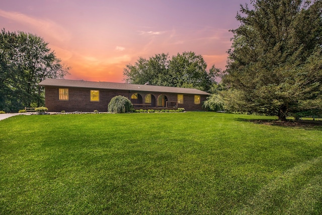 ranch-style house with a lawn