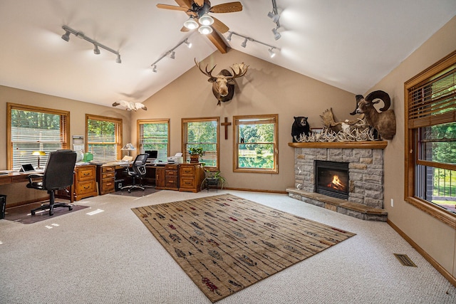 10133 W Allen Rd, Fowlerville, MI 48836 - carpeted office featuring rail lighting, a ceiling fan, a fireplace, vaulted ceiling, and baseboards